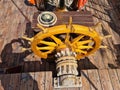 The large wooden steering wheel of the sailing ship Standart moored at the pier in the Lavtian capital Riga in July 2021 Royalty Free Stock Photo