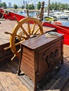 The large wooden steering wheel of the sailing ship Standart moored at the pier in the Lavtian capital Riga in July 2021 Royalty Free Stock Photo