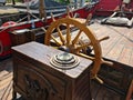 The large wooden steering wheel of the sailing ship Standart moored at the pier in the Lavtian capital Riga in July 2021 Royalty Free Stock Photo