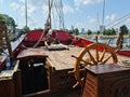 The large wooden steering wheel of the sailing ship Standart moored at the pier in the Lavtian capital Riga in July 2021 Royalty Free Stock Photo