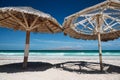 Large wooden umbrellas at sandy tropical beach Royalty Free Stock Photo