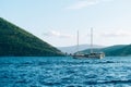 A large wooden yacht with two masts sails on the Bay of Kotor.