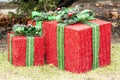 Large wrapped Christmas present ornaments on front lawn