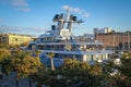 Large yacht in an urban environment on a sunny day. Embankment with palm trees and a boat close-up. Travel, holidays in Europe