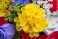 Large yellow artificial flower surrounded by smaller flowers close view Royalty Free Stock Photo