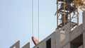 Large yellow construction crane above the building. Royalty Free Stock Photo