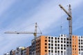 Large yellow construction crane, multi-storey house against the Royalty Free Stock Photo