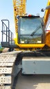 Large yellow crawler crane operator cabin front look