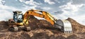 A large yellow crawler excavator moving stone or soil in a quarry. Heavy construction hydraulic equipment. excavation. Rental of