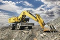 A large yellow crawler excavator moving stone or soil in a quarry. Heavy construction hydraulic equipment. excavation. Rental of