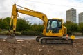 A large yellow excavator on new construction site Royalty Free Stock Photo