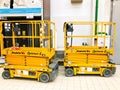 Mobile hydraulic lift for lifting people and cargo on racks in a supermarket at the warehouse. Belarus, Minsk, October 5, 2018