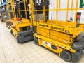 Mobile hydraulic lift for lifting people and cargo on racks in a supermarket at the warehouse. Belarus, Minsk, October 5, 2018