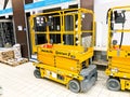 Mobile hydraulic lift for lifting people and cargo on racks in a supermarket at the warehouse. Belarus, Minsk, October 5, 2018