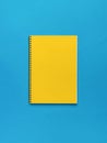 A large yellow notebook on a blue background. Flat lay Royalty Free Stock Photo