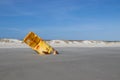 Large yellow ocean buoy on the beach