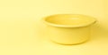A large yellow plastic basin on a yellow background Royalty Free Stock Photo