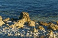 Large yellow rocks against the backdrop of the blue sea at sunset. Sea stones and rocks of different sizes Royalty Free Stock Photo