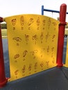 Yellow sign language alphabet guide board on children`s playground