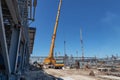 A large yellow truck crane stands ready to work on the construction site Royalty Free Stock Photo