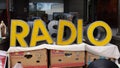 Large Yellow Vintage Letters that Spell RADIO Seen at an Antique Show