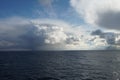 Largely overcast sky with heavy rainfall clouds bringing abundant rainfall and atmospheric precipitation observed on Pacific ocean