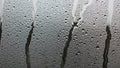 Larger droplets have formed rivulets, flowing vertically down the surface Royalty Free Stock Photo