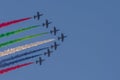 Largest Military Show at Marjan Island with coordinated military aircrafts showing the UAE flag colors on the bright blue sky