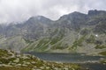 The largest mountain lake on slovakian side of High Tatras, Hincovo pleso surrounded by rocky mountains Royalty Free Stock Photo