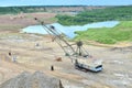 Largest Walking Dragline excavator working in dolomite open-pit. Full-revolving electric digging walking machine with dragline Royalty Free Stock Photo