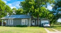 Modern rural life in Texas. Ancient wooden house and lawn Royalty Free Stock Photo