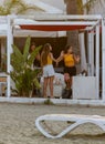 Three girls are dancing at a beach bistro at MCKenzie beach in L