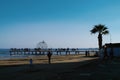 People strolling along Finikoudes beach in Larnaca on a sunny day in January.