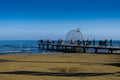 People strolling along Finikoudes beach in Larnaca on a sunny day in January.