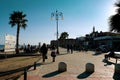People strolling along Finikoudes beach in Larnaca on a sunny day