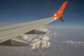 SkyUp Airlines aircraft wing flying against clear blue sky