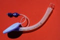 Laryngeal mask airway for emergency medical help on a red background. Royalty Free Stock Photo