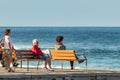 Las Americas,Tenerife, Spain - January 21, 2020: People on the waterfront, walking on promenade and relax sitting on benches near