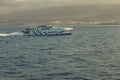 Las Americas, Tenerife, Spain - May 25, 2019: View to the coastline and small high-speed ferry from another ferry departing for Royalty Free Stock Photo