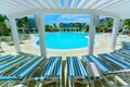 Amazing inviting view of swimming pool with tranquil turquoise clear water, sunny gorgeous day Royalty Free Stock Photo