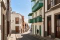 Las Palmas, Gran Canaria. Man walking his dog in an old street leading to the ocean. Royalty Free Stock Photo