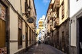 Las Palmas, Spain - Feb 22, 2023: Small pedestrian cobblestone street in Vegueta. Las Palmas, Gran Canaria, Spain