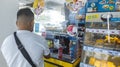 Las Pinas, Metro Manila, Philippines - A man buys an energy drink at an Uncle John\'s convenience store inside BF
