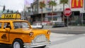 LAS VEGAS, NEVADA USA - 7 MAR 2020: Yellow vacant mini taxi cab close up on Harmon avenue corner. Small retro car model. Little