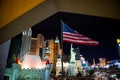 Las Vegas at night. American flag in front.