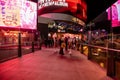 LAS VEGAS - November 11, 2020, a girl's feather stands on a night street illuminated by multi-colored lights, Las Vegas