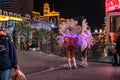 LAS VEGAS - November 11, 2020, a girl`s feather stands on a night street illuminated by multi-colored lights, Las Vegas is the