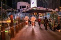 LAS VEGAS - November 11, 2020, a girl's feather stands on a night street illuminated by multi-colored lights, Las Vegas