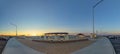 Empty parking area with petrol station in panoramic view in sunset