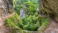 Las Xanas gorge with unrecognizable tourists hiking